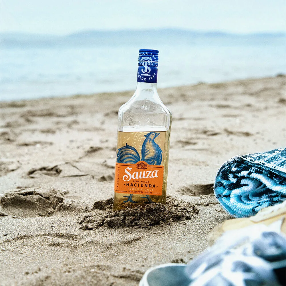 Hacienda Gold bottle in beach Sauza